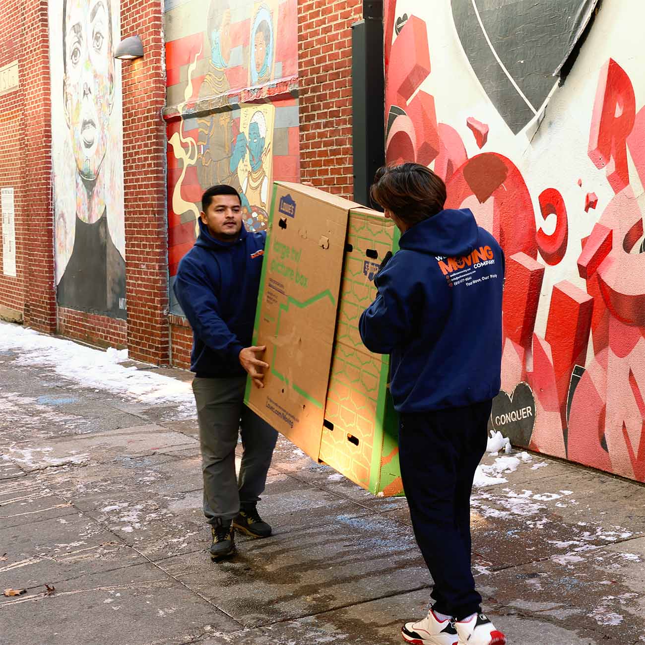 Movers carrying a box